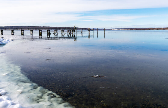 Image of an old pier with gulls on the railing at Stockton Springs Maine on a winter day.