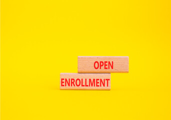 Naklejka premium Open Enrollment symbol. Wooden blocks with words Open Enrollment. Beautiful yellow background. Business and Open Enrollment concept. Copy space.