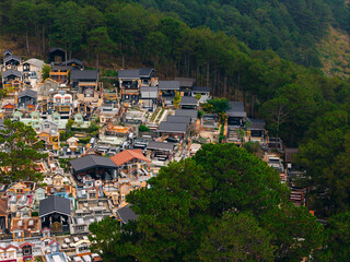 Obraz premium Hillside cemetery terraces nestled at forest edge overlooking valley Da Lat Vietnam