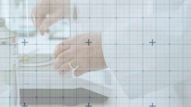 Senior lab tech raising pipette and placing tiny yellow specimen with forceps into jar for testing