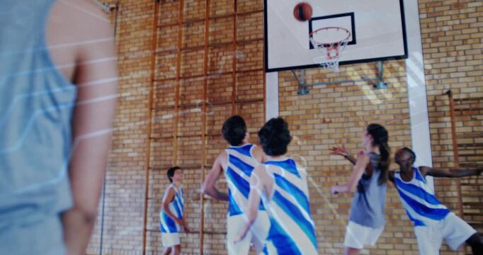 Shooting in gray top releasing ball to score at hoop, blue jerseys contesting rebound, copy space