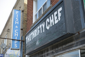 Naklejka premium old sign above entrance to The Thrifty Chef Shop, a home goods store, located at 369 Donlands avenue, East York, Toronto