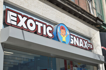 Naklejka premium exterior building facade and sign of Exotic Snax GTA, a candy store, located at 288 Queen St W, Toronto