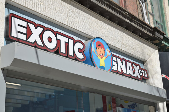 exterior building facade and sign of Exotic Snax GTA, a candy store, located at 288 Queen St W, Toronto