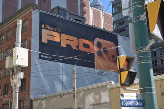 looking southeast to wall mural advertisement for Apple iPhone 17 on the west facing wall of 409 King St W at Spadina Av, Toronto