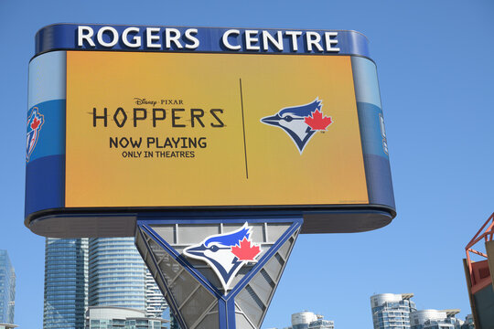 Rogers Centre Gardiner LED pylon sign with Disney Pixar  promotional ad and Toronto Blue Jays logo