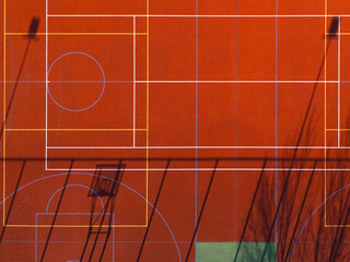 Red multi sport court with game lines, abstract aerial background © Kacper