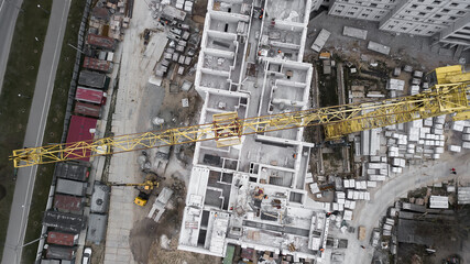 Fototapeta premium aerial top view of construction site. industrial machinery building new apartment buildings