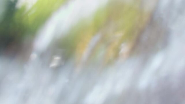 First Person View Passing Through Falling Water of Jungle Waterfall With Powerful Fresh Stream Flowing Over Brown Rocks in Tropical Forest Showing Dynamic Nature and Adventure Exploration