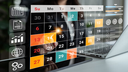 A businesswoman interacts with a digital calendar interface showing planning elements and analytics in a modern office setting. Ideal for themes of productivity and organization. Gantry