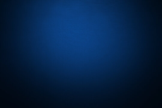 Deep navy blue gradient background with soft vignette and subtle light center. Dramatic backdrop for modern design, technology presentations, luxury branding, elegant wallpaper. Ombre, blur effect