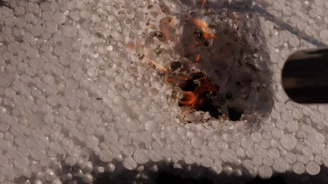 close-up inspection of polystyrene foam for burning