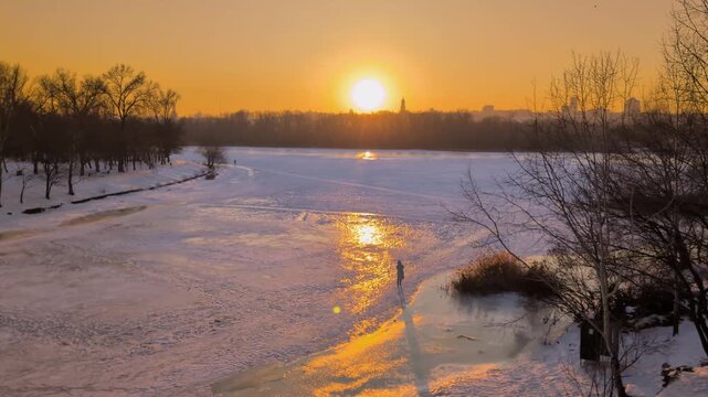 Beautiful sunset view of Kyiv in winter with frozen Dnipro River