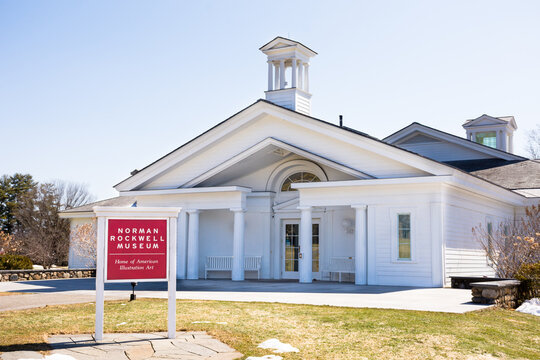Stockbridge, MA - USA: Colorful entrance sign to the Norman Rockwell museum on a sunny early spring day with museum in the background. Horizontal orientation.