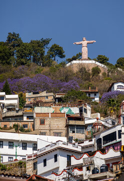 taxco mexico, hillside houses, mountain town, christ statue, mexican village, scenic town, travel destination, mountain architecture, tourism mexico, colonial town, mexican landscape