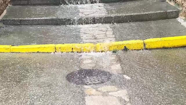 torrent of water and heavy rain in the streets and stairwell