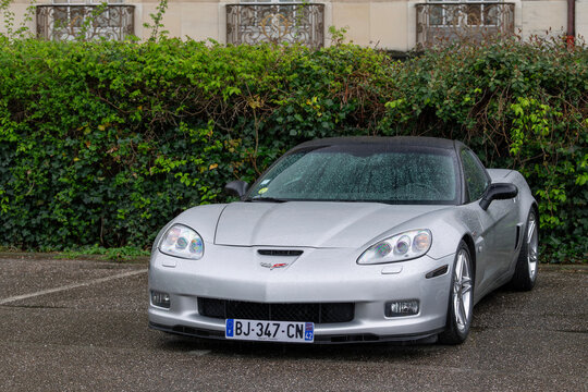 Nancy, France - April 16th 2025 : View on a grey Chevrolet Corvette C6 Z06 parked on a parking lot in the rain.