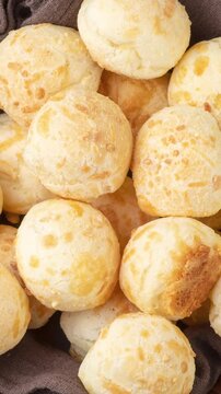Typical brazilian cheese bun in a basket over wooden table