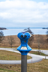 Fototapeta premium Coin operated telescope on an island in a lake