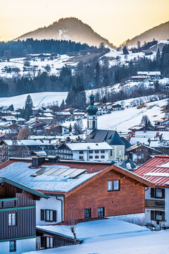 Reit im Winkl winter sports resort, view of the town with church at sunset