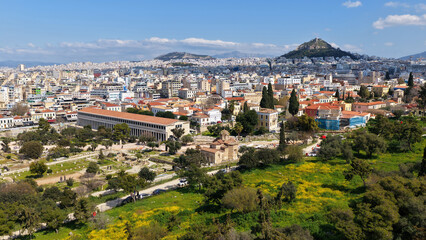 Naklejka premium Aerial drone portrait photo of ancient Roman Market featuring tower of Winds and Gate of Athena in the heart of Athens historic centre built in Plaka district, below Acropolis hill, Attica, Greece