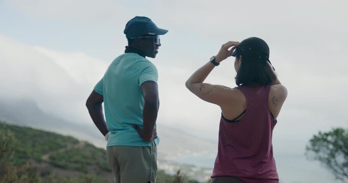 Fitness, back view or couple outdoor, talking or interracial people on workout break for wellness. Training, man and woman with conversation in nature for exercise, health and resting together