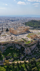 Naklejka premium Aerial drone photo above Acropolis hill and the Parthenon featuring Propylaea and porch of the Caryatids, Athens historic centre, Attica, Greece