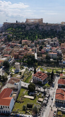 Naklejka premium Aerial drone portrait photo of ancient Roman Market featuring tower of Winds and Gate of Athena in the heart of Athens historic centre built in Plaka district, below Acropolis hill, Attica, Greece