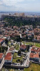Naklejka premium Aerial drone portrait photo of ancient Roman Market featuring tower of Winds and Gate of Athena in the heart of Athens historic centre built in Plaka district, below Acropolis hill, Attica, Greece