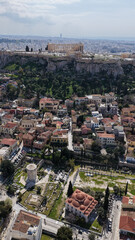 Naklejka premium Aerial drone portrait photo of ancient Roman Market featuring tower of Winds and Gate of Athena in the heart of Athens historic centre built in Plaka district, below Acropolis hill, Attica, Greece