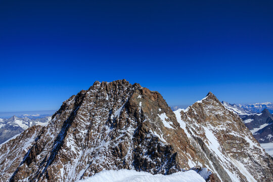 Mountain glacier panorama of Monte Rosa massif with summits Dufourspitze (left) and Nordend (right) seen from Zumsteinspitze in Pennine Alps, Switzerland