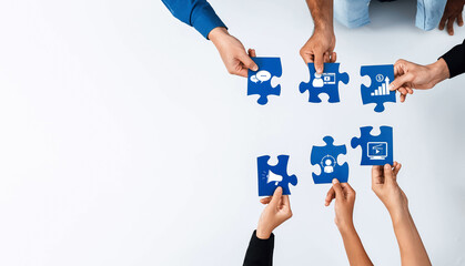 Obraz premium Diverse hands come together to join puzzle pieces depicting essential marketing concepts, highlighting teamwork in strategizing for business success and innovation. Amity