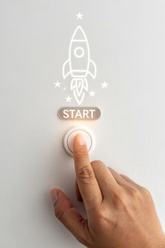 Launching a startup closeup of finger pressing start button on virtual screen with rocket icon