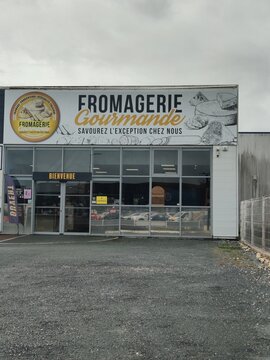 Saujon, France - October 25, 2025: Super U. Fromagerie Gourmande storefront with welcoming sign and large display windows, showcasing a cheese shop in a commercial area