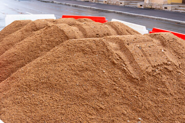 pile of sand for building or laying pipes. construction development of infrastructure, laying of underground utilities. focus connectivity and progress.