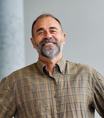 Fototapeta premium A man in a blue shirt is standing in office, businessman portrait