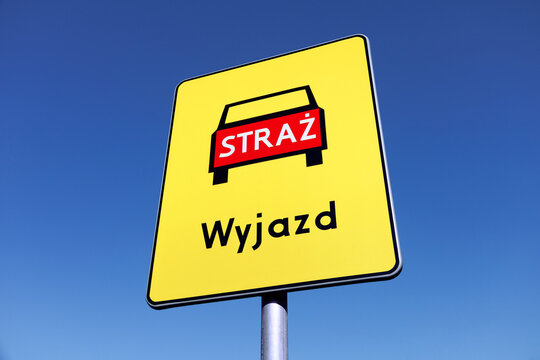 Exit way for fire trucks - Polish road sign on a blue sky background.