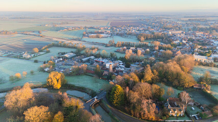 Naklejka premium Rural farmland and English village town, Lincolnshire. Sunset in the countryside
