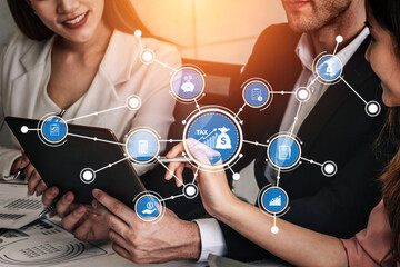 Team members engage in a collaborative meeting focused on tax planning, utilizing digital tools and...