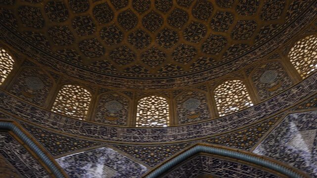 Low angle view of the dome of Sheikh Lotfollah Mosque in Isfahan, Iran, showing detailed Persian tile patterns and Islamic architecture. Famous historic mosque located on Naqsh e Jahan Square