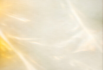Obraz premium Soft warm golden sunlight reflections on neutral textured background
