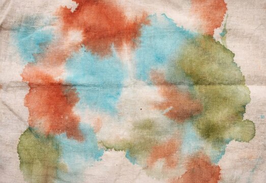 Abstract watercolor texture on vintage paper with blue, rust and olive stains
