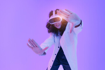 Asian woman experiencing immersive virtual reality with headset and excited gesture in neon light,...