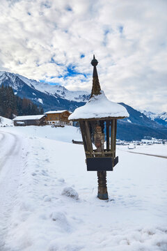 Beautiful winter panorama with wayside cross near Bramberg am Wildkogel, in the Salzburg region, Austria.