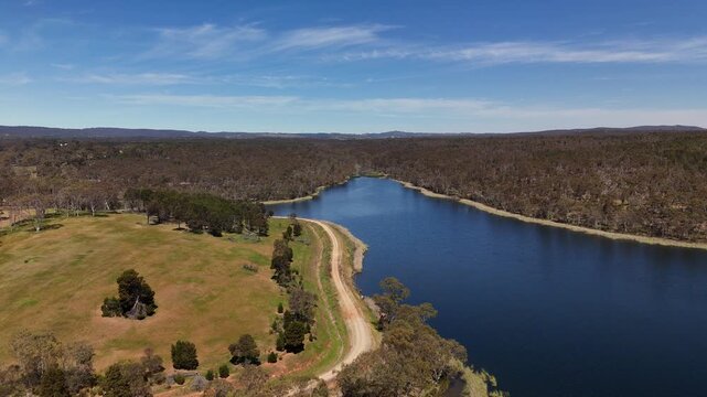 Barossa Reservoir Reserve, Williamstown, South Australia &ndash; 4K aerial drone footage of Whispering Wall dam, blue reservoir lake and surrounding forest landscape