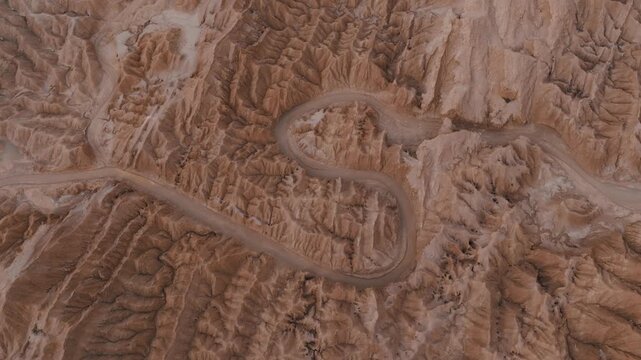 Drone view of rugged desert mountains and dry valleys in northern Chile. Erosion has sculpted dramatic patterns across the arid landscape.