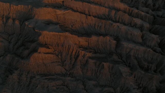 Drone view of rugged desert mountains and dry valleys in northern Chile. Erosion has sculpted dramatic patterns across the arid landscape.