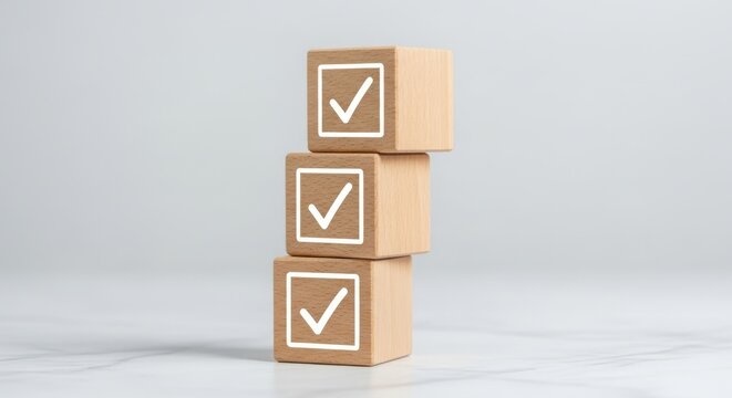 Three wooden blocks with checkmarks stacked vertically on a white surface