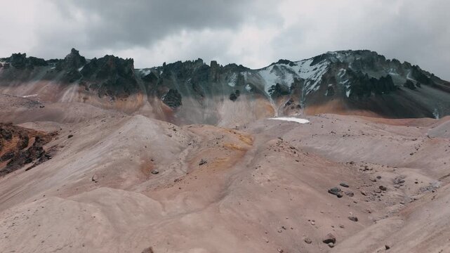 Aerial view of volcanic peaks, alpine lakes and rugged terrain in Sajama National Park, Bolivia. A remote high-altitude landscape in the Andes.