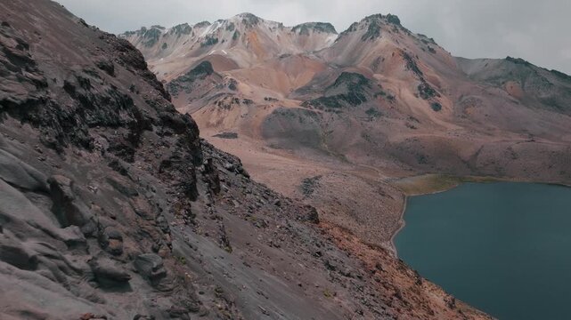 Aerial view of volcanic peaks, alpine lakes and rugged terrain in Sajama National Park, Bolivia. A remote high-altitude landscape in the Andes.